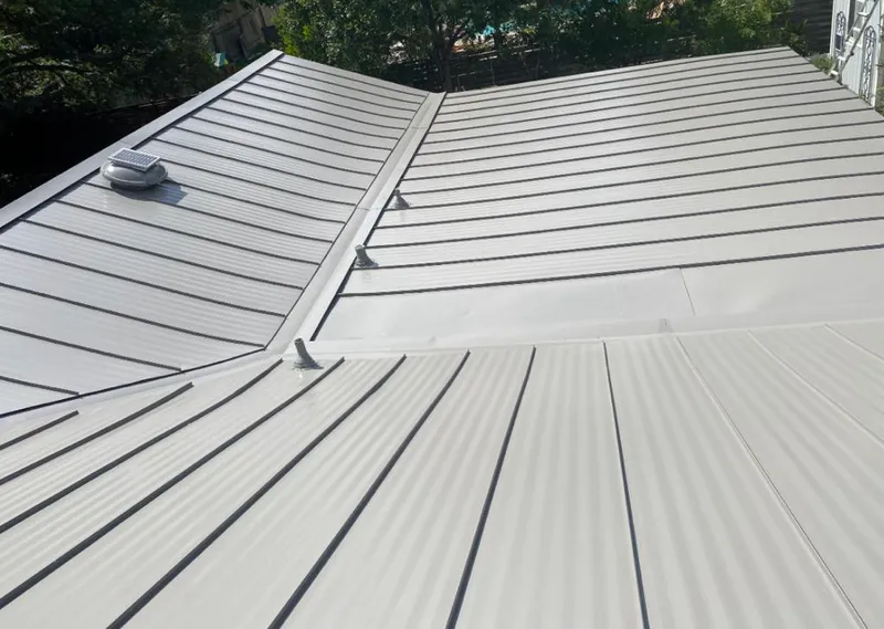 Solar attic fan installed on a metal roof for Roof Ventilation in McCalla